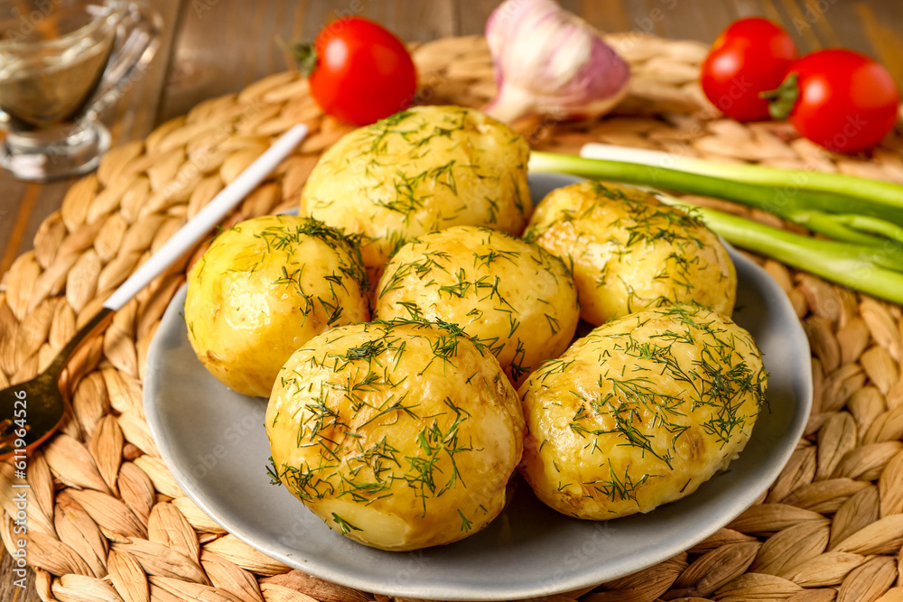 Plate of boiled baby potatoes with dill and green onion, closeup