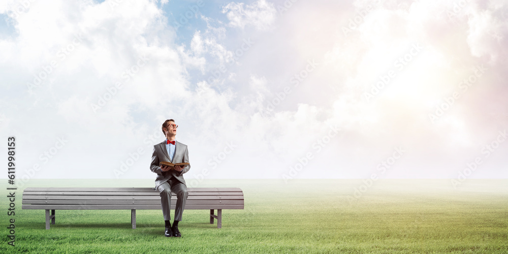 Young businessman or student studying the science in summer park