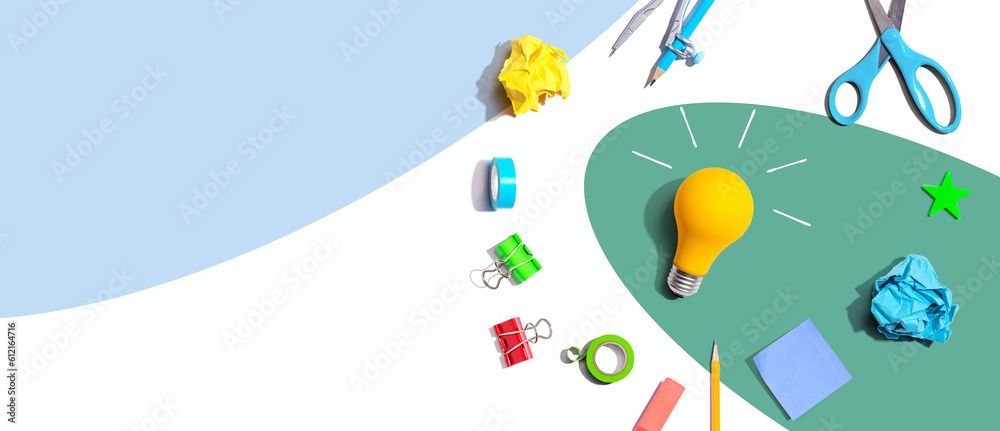 Idea light bulb with school supplies overhead view - flat lay