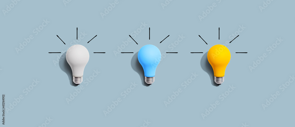 Idea and creativity concept with white, blue and yellow light bulbs - Flat lay