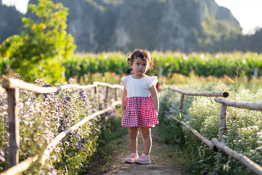 portrait of a little girl in flower garden