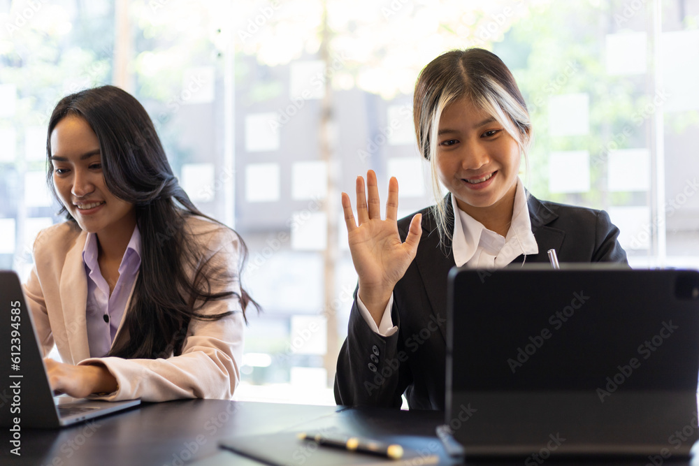 Businesswoman secretary colleague working with laptop in office. Two receptionists work at the count