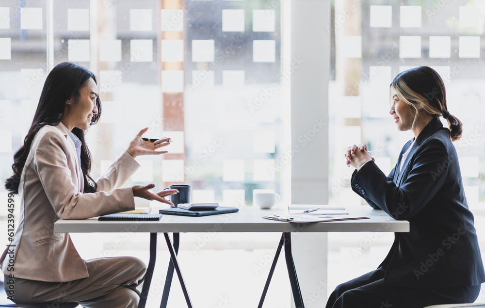 Businesswoman discussing with colleagues in the office, job interview.