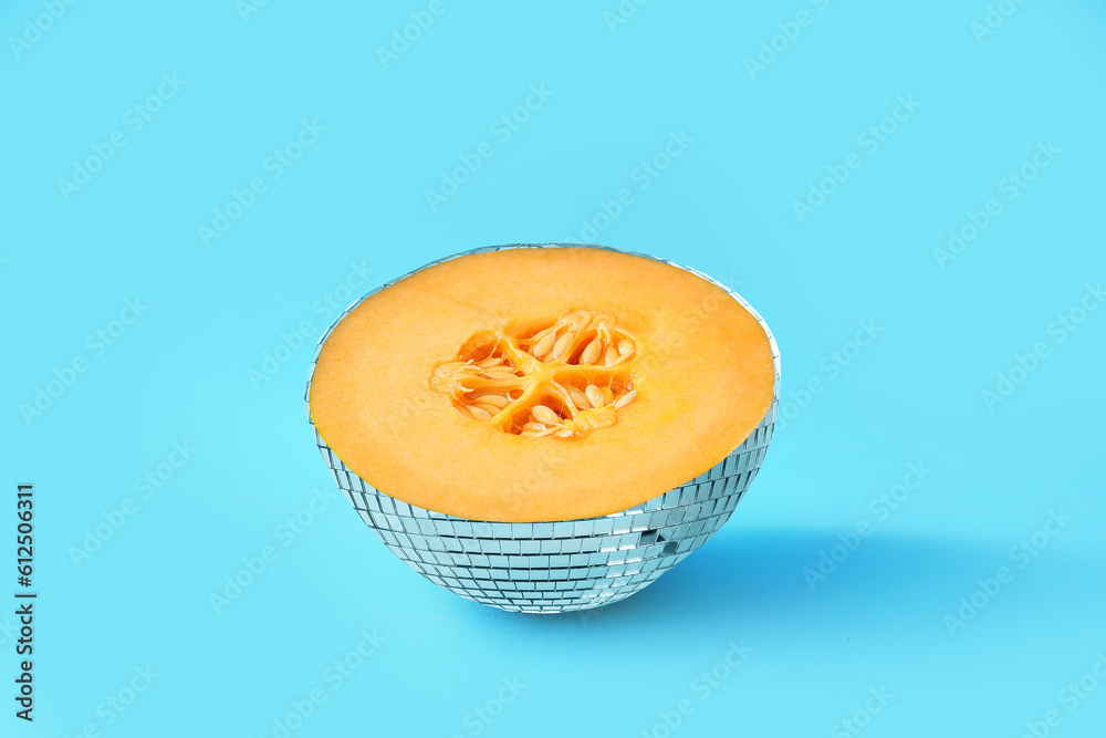 Disco ball with melon inside on light blue background