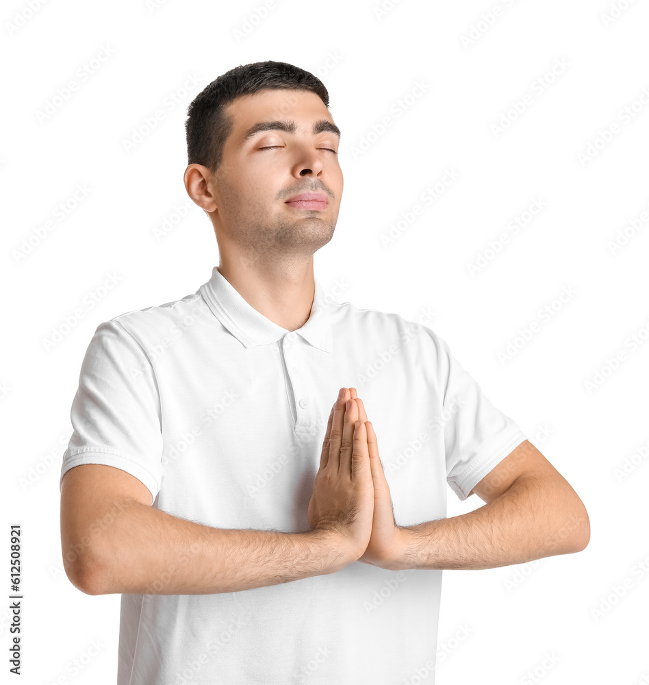 Young guy meditating on white background