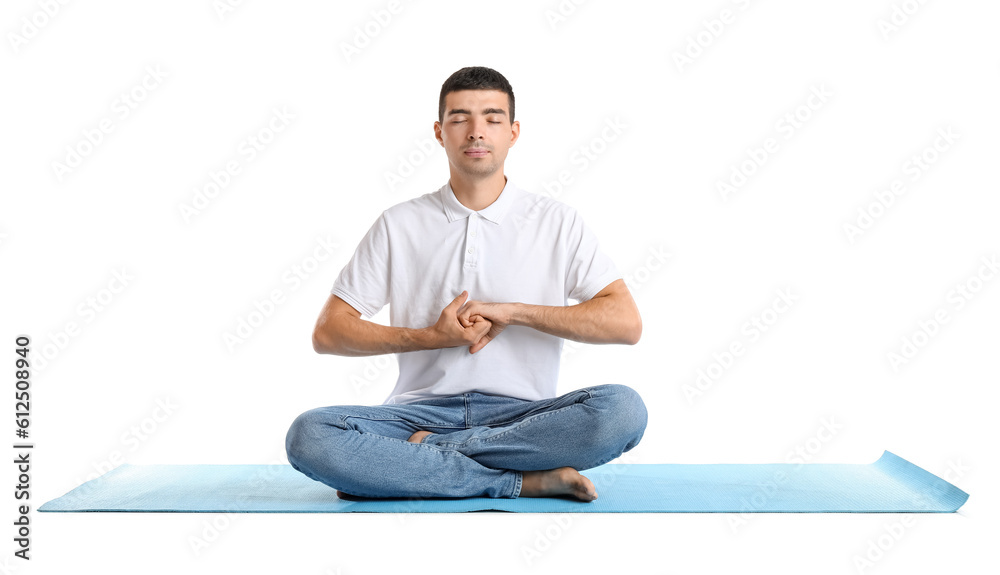 Young man meditating on white background