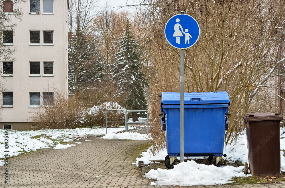 View of garbage containers in city on winter day