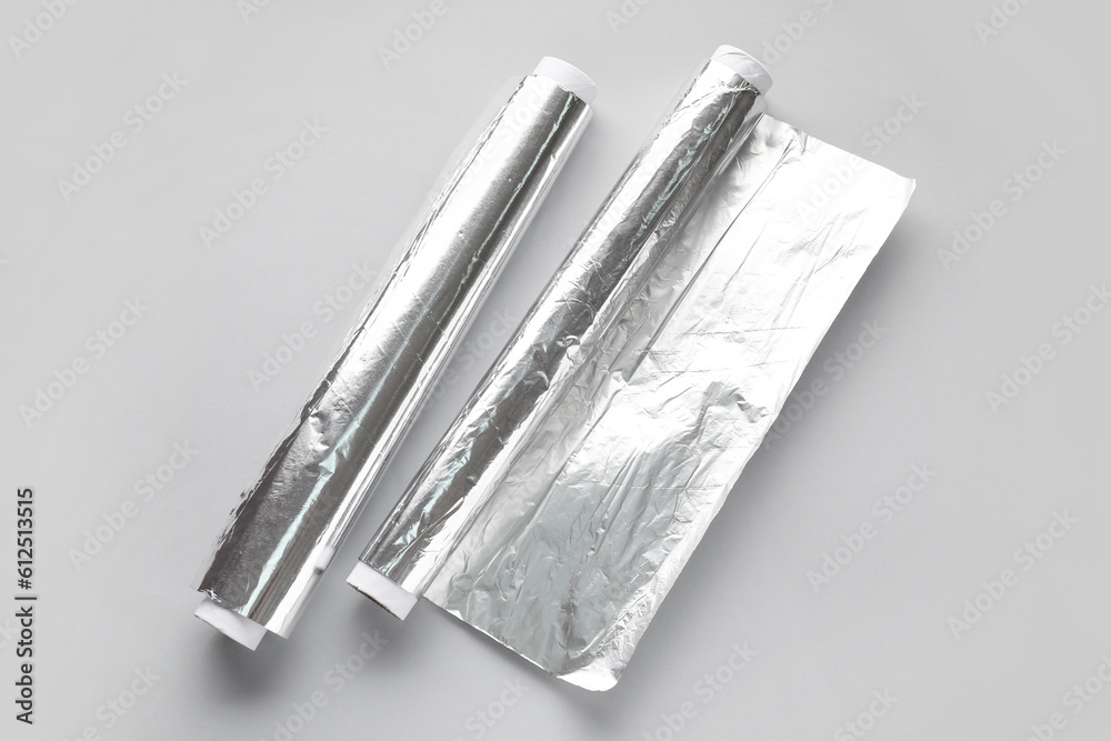 Aluminium foil rolls on grey background