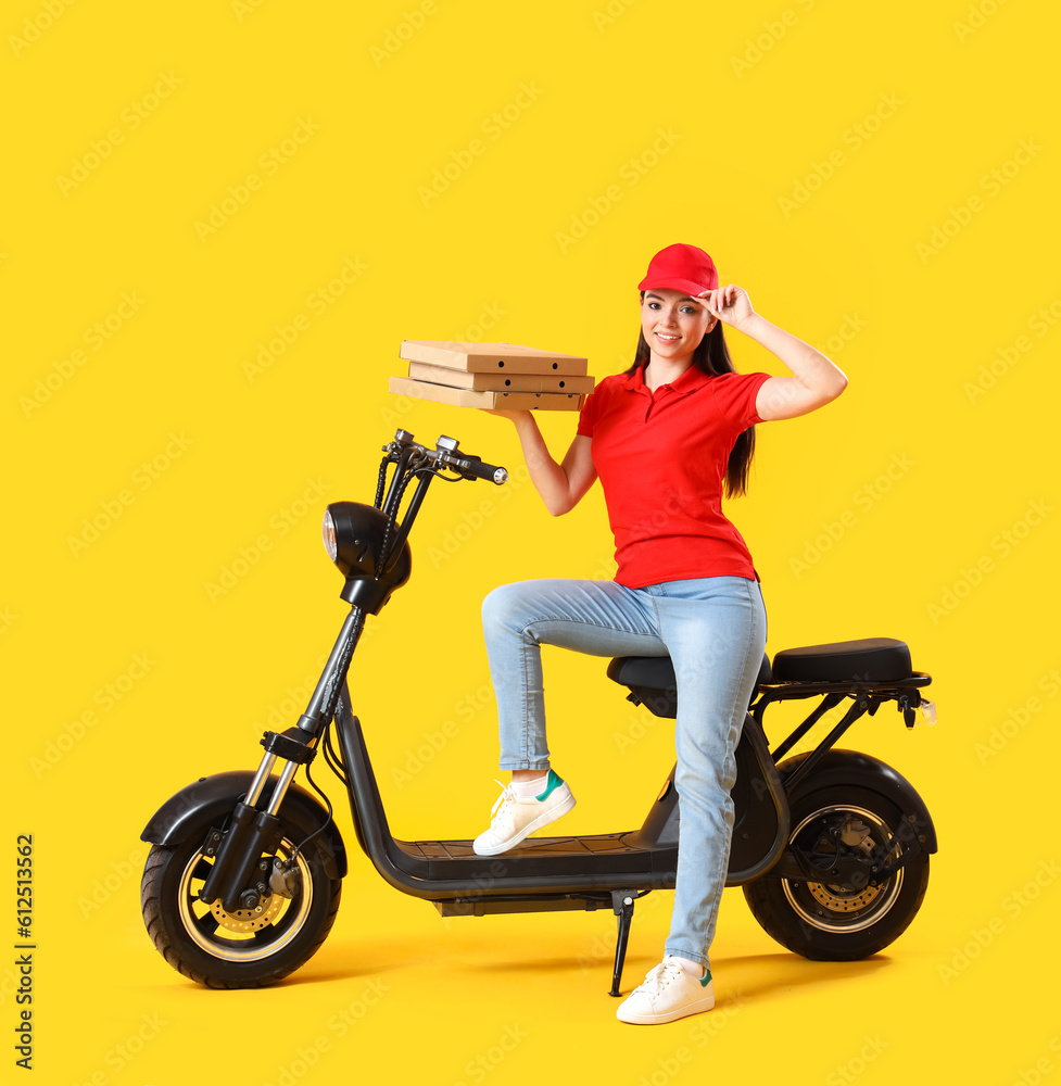 Female courier with scooter and tasty pizza on yellow background