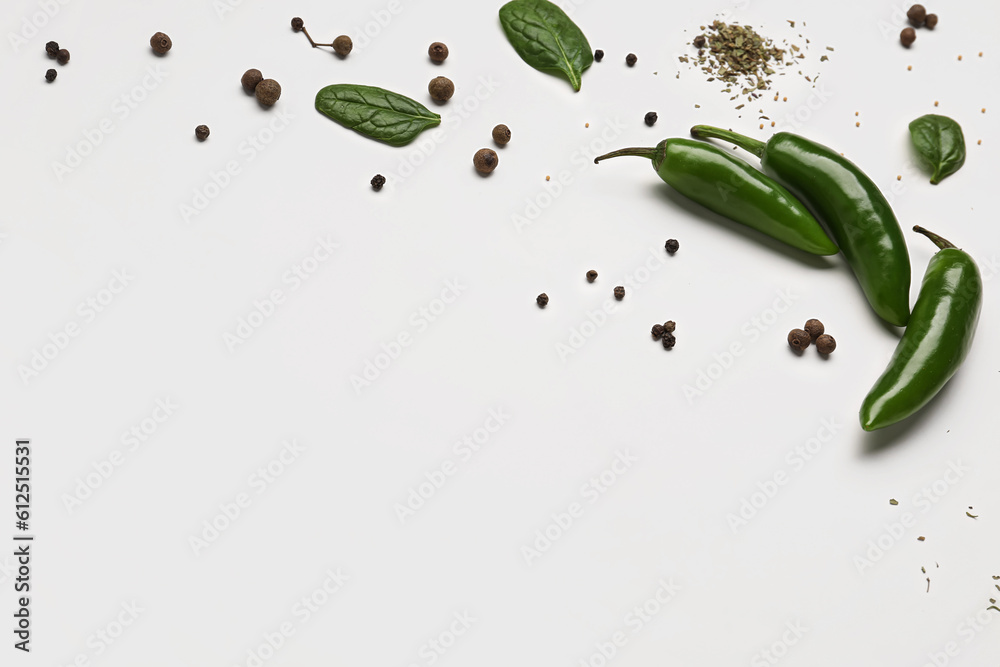 Composition with fresh chili peppers and spices on light background