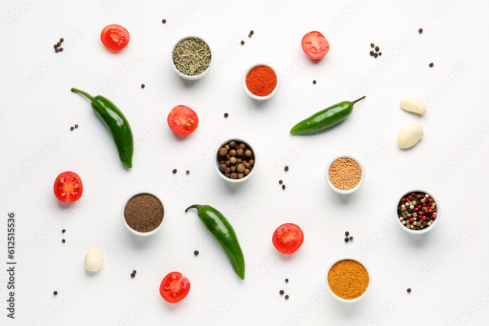 Composition with different spices and vegetables on light background