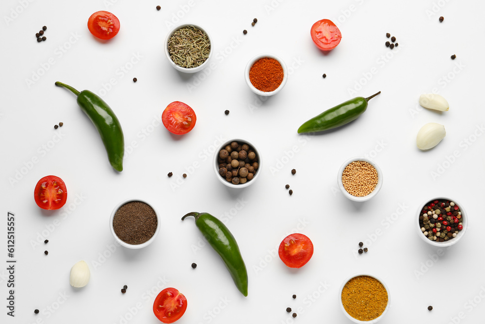 Composition with different spices and vegetables on light background