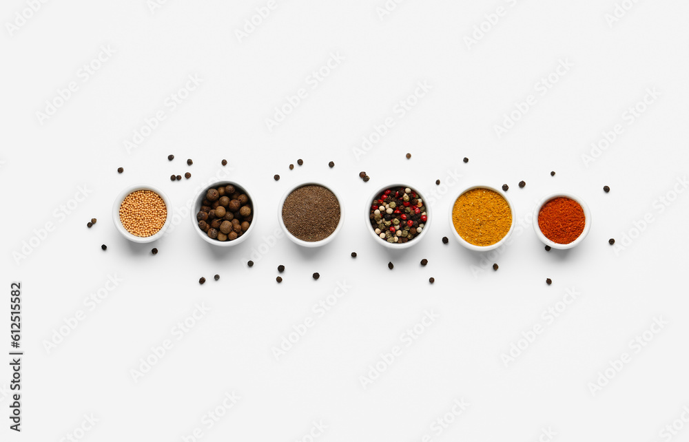 Composition with bowls of fresh aromatic spices on light background