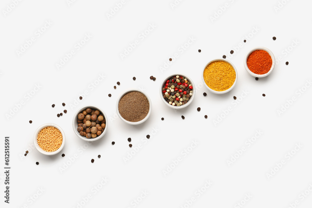 Composition with bowls of fresh aromatic spices on light background