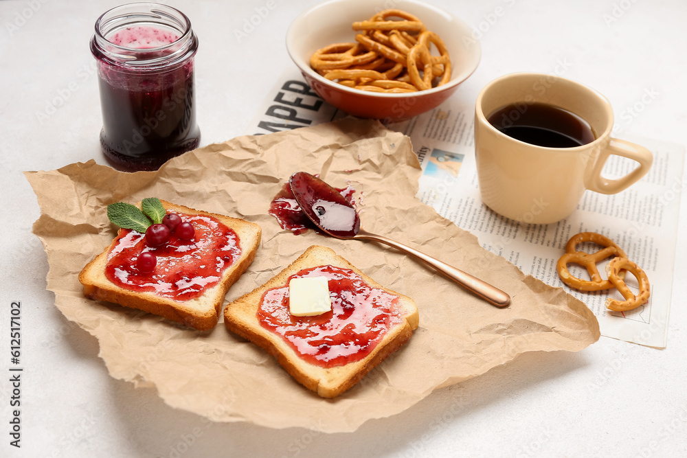 Tasty toasts with cranberry jam and cup of coffee on light background