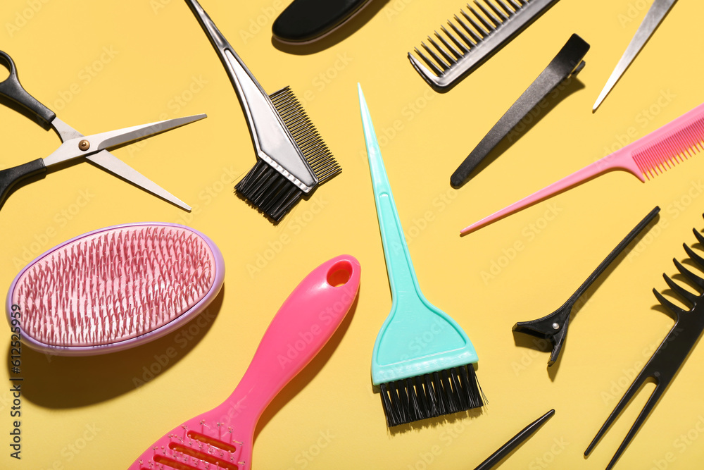 Composition with hairdressing accessories on yellow background