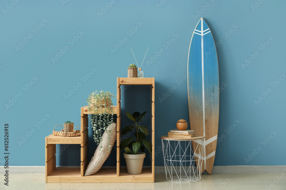 Interior of room with surfboard, table and shelves