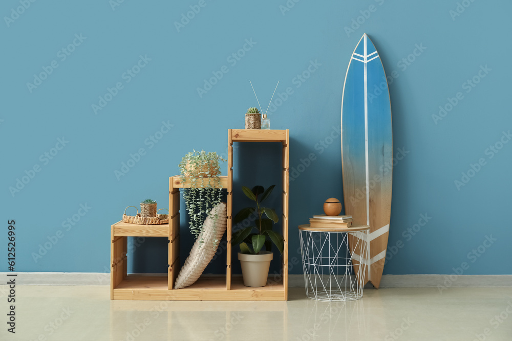 Interior of room with surfboard, table and shelves