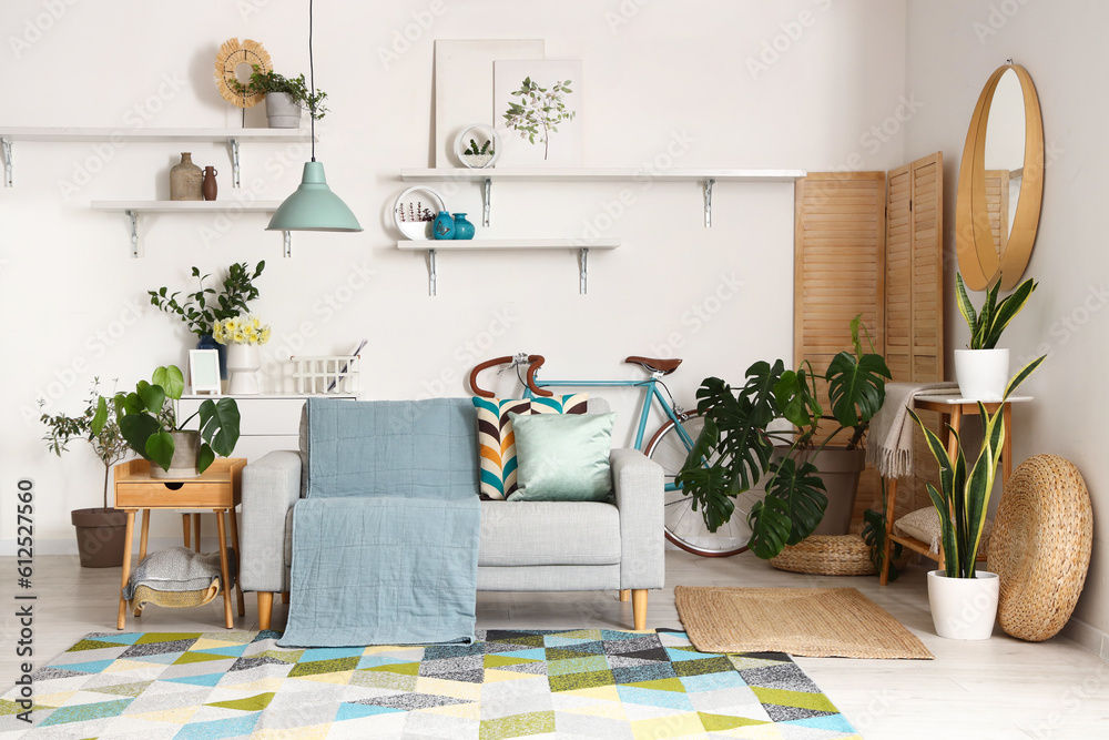 Interior of stylish living room with cozy grey sofa