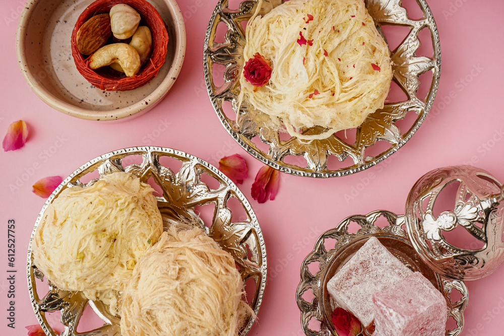 Plates with tasty Turkish Pismaniye on pink background, closeup