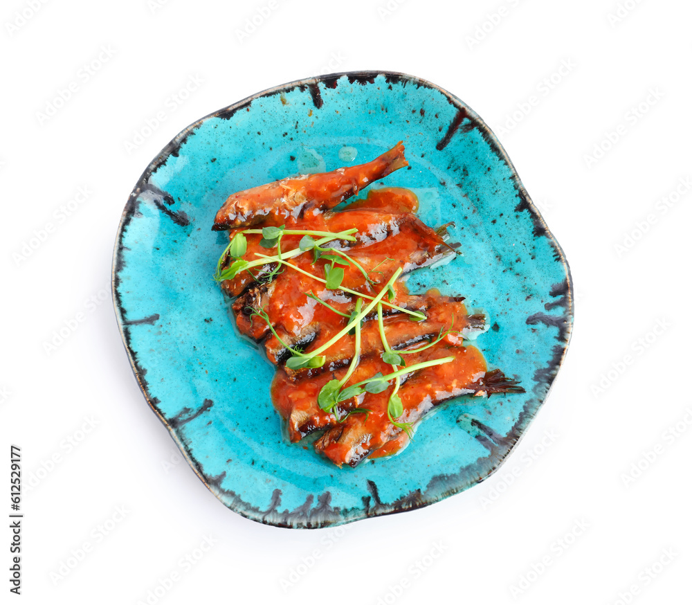 Plate with canned fish in tomato sauce isolated on white background