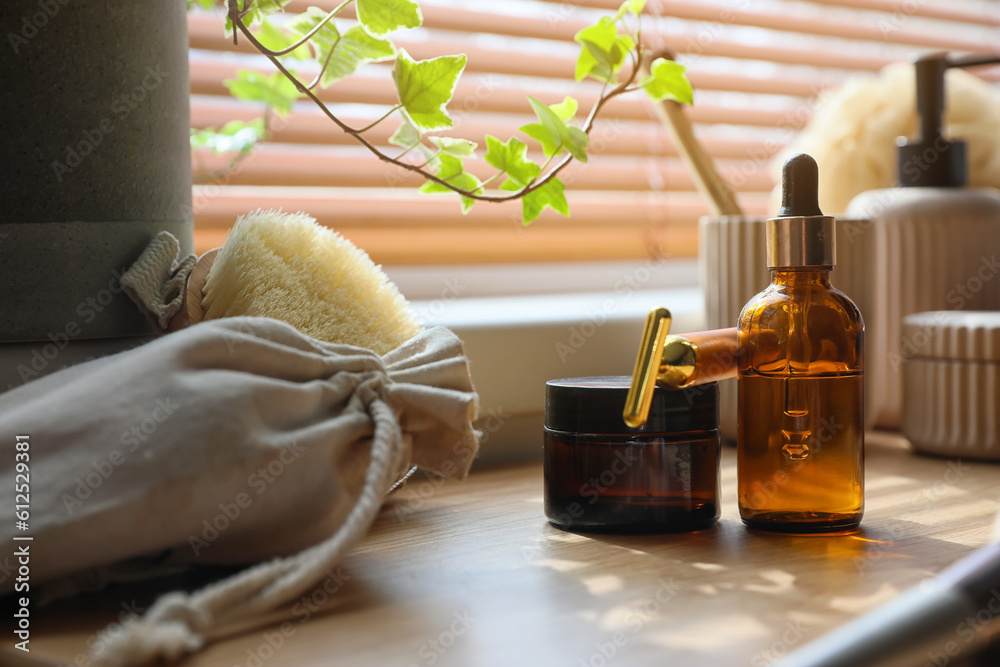 Bath accessories with facial massage tool on table in room, closeup