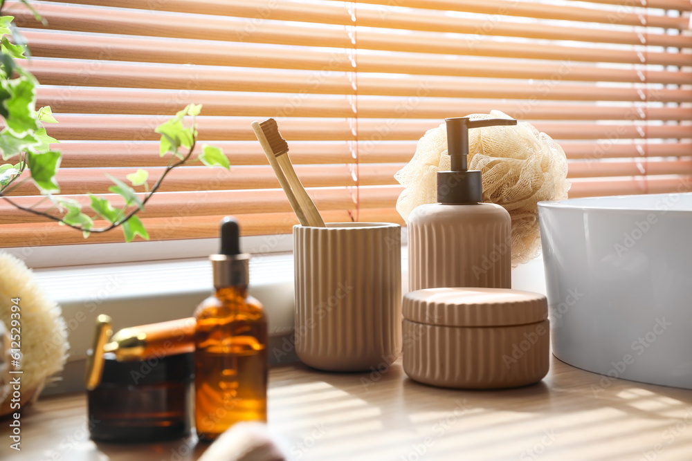 Bath accessories with toothbrushes on table in room, closeup