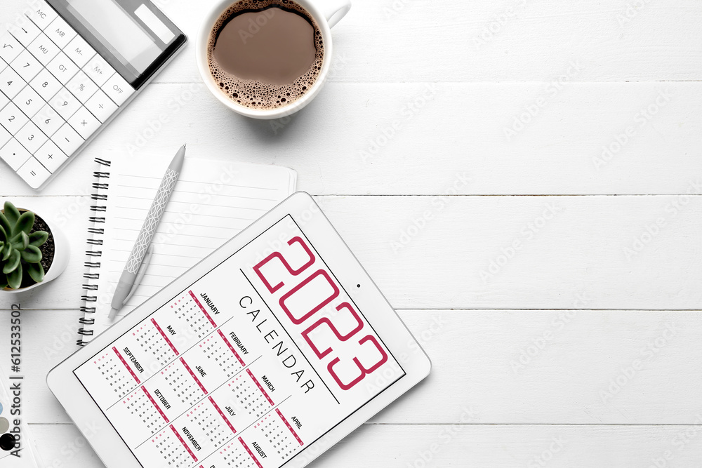 Composition with calendar, cup of coffee and calculator on white wooden background