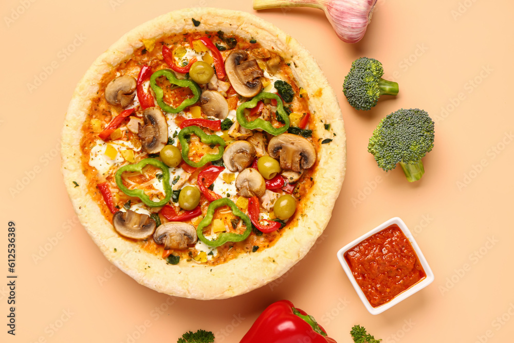 Vegetable pizza with ingredients and sauce on beige background