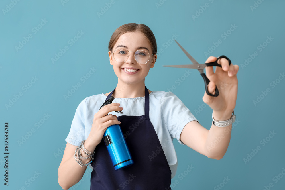 Female hairdresser with scissors and spray on blue background