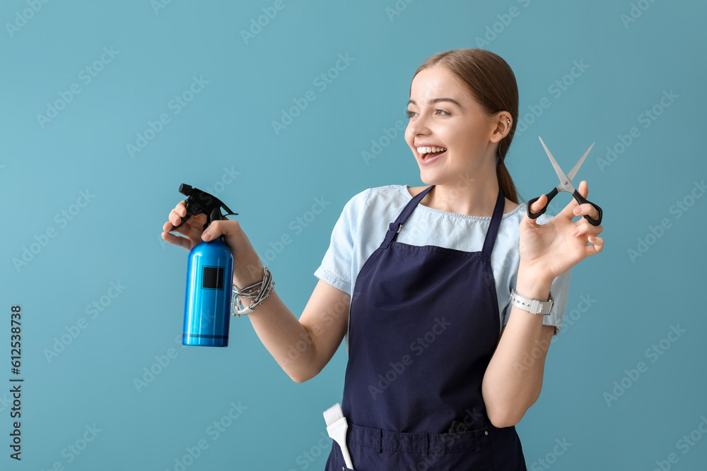 Female hairdresser with scissors and spray on blue background