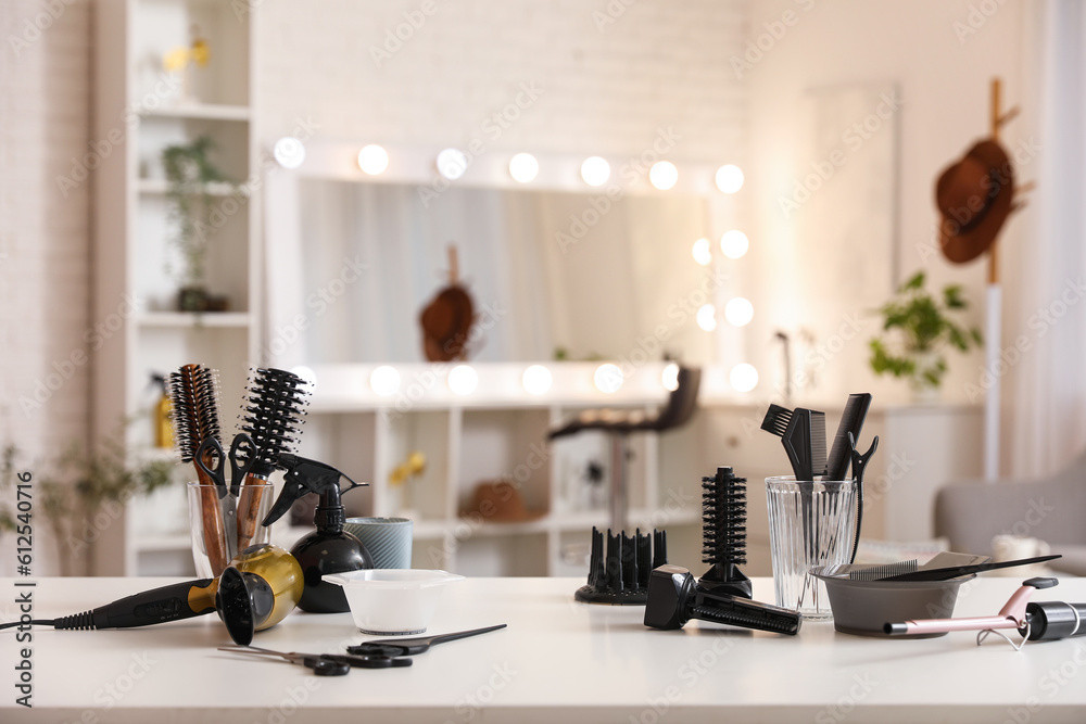 Different hairdressing tools on table in beauty salon