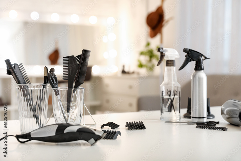 Different hairdressing tools on table in beauty salon