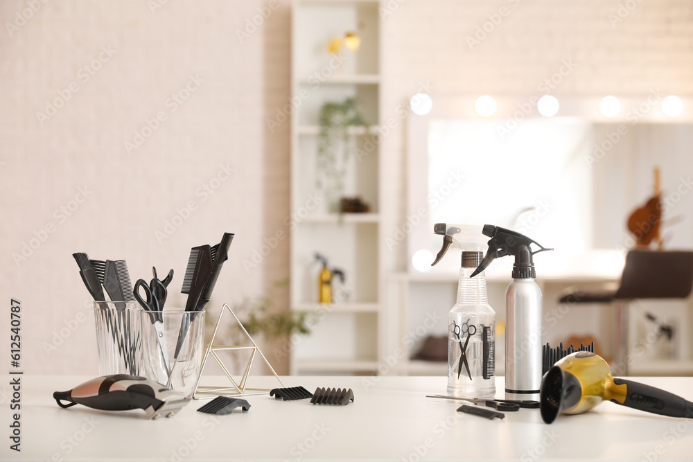 Different hairdressing tools on table in beauty salon