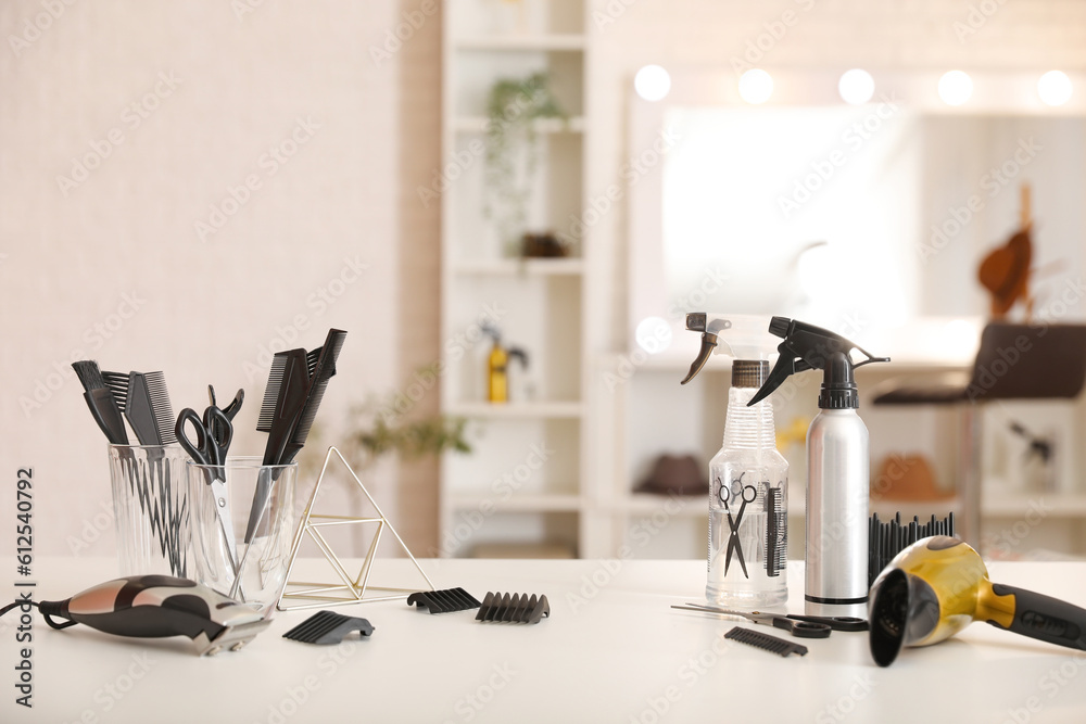 Different hairdressing tools on table in beauty salon