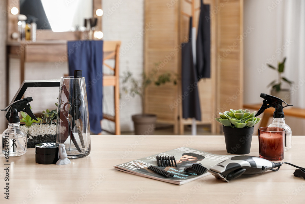 Different hairdressing tools on table in beauty salon