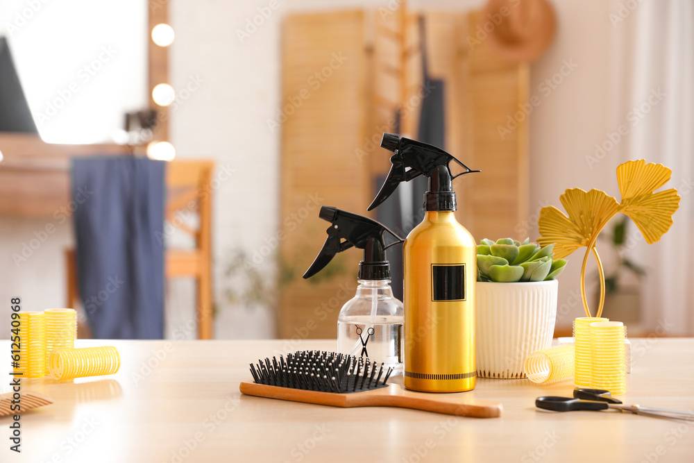 Different hairdressing tools on table in beauty salon