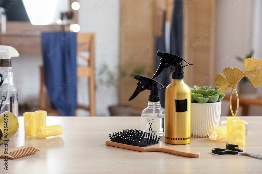 Different hairdressing tools on table in beauty salon