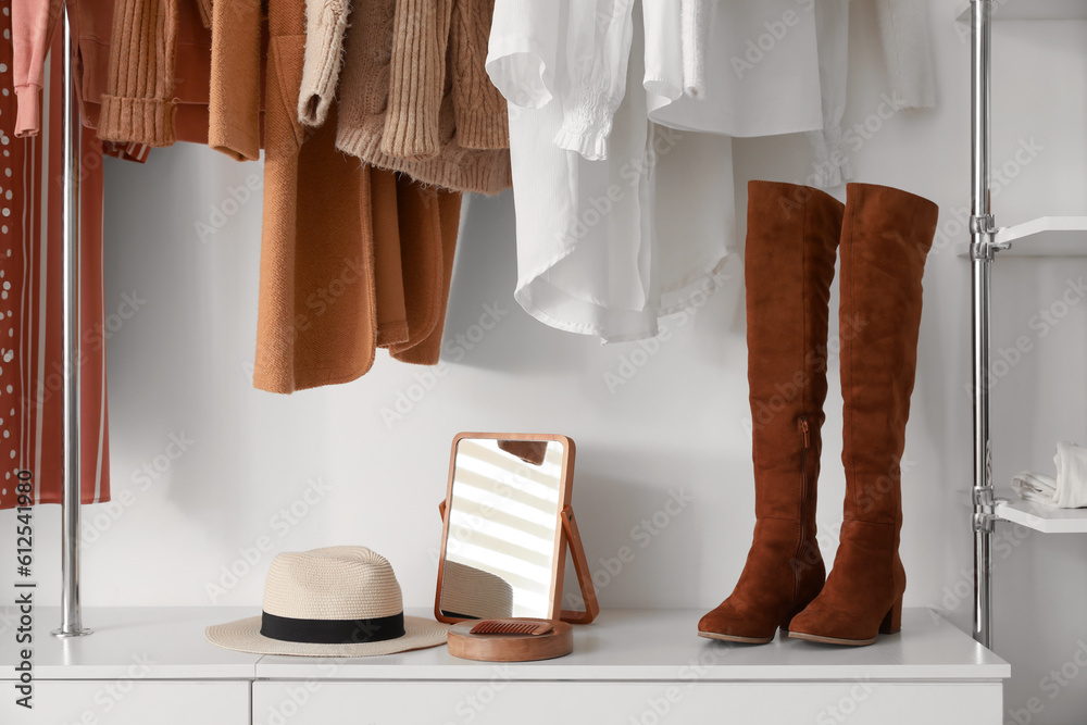 Mirror with hat and shoes on shelf in boutique