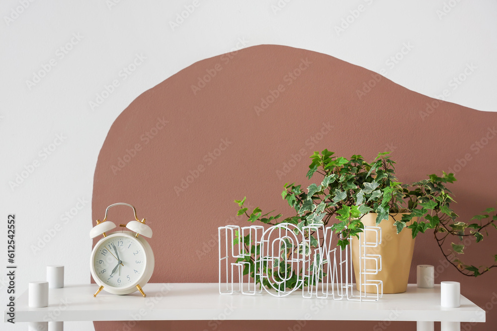 Alarm clock with houseplant on shelf in childrens bedroom