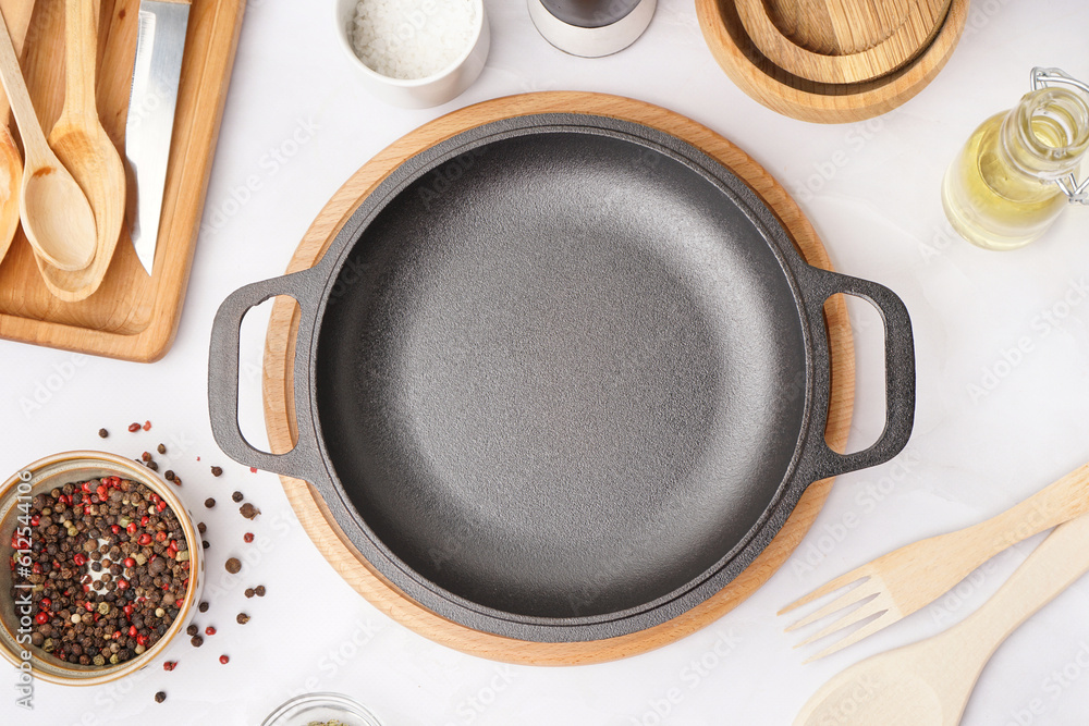 Board with frying pan on white table