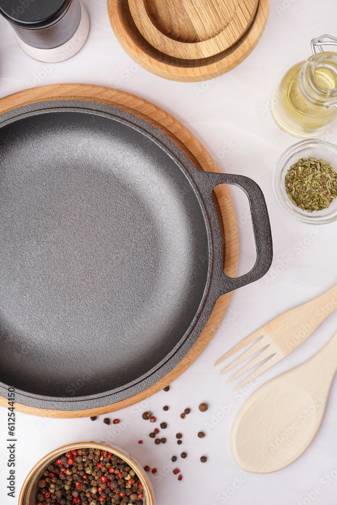 Board with frying pan on white table