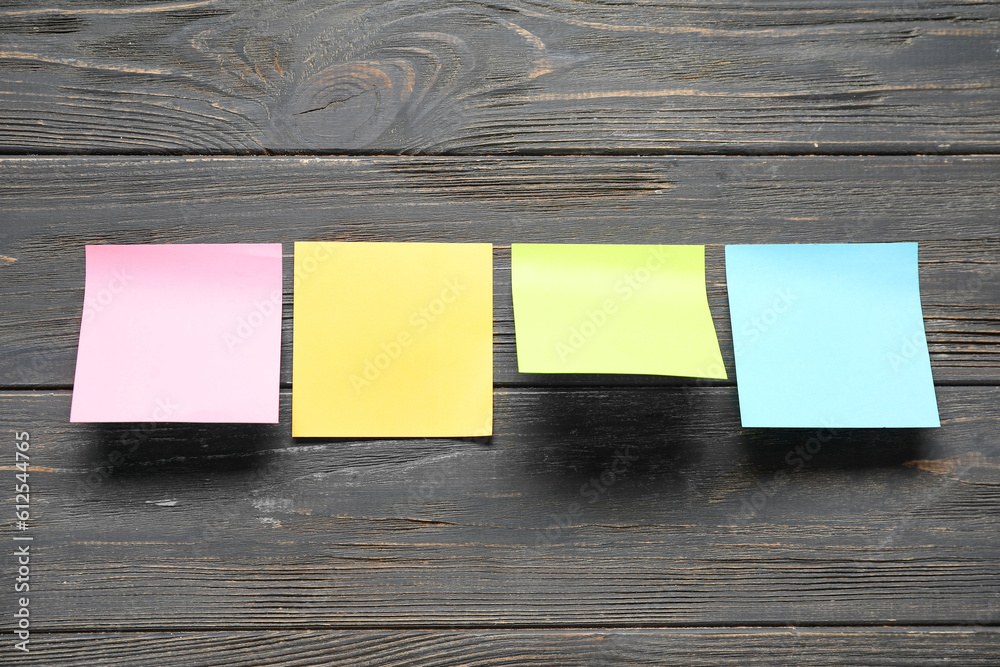 Sticky notes on black wooden background