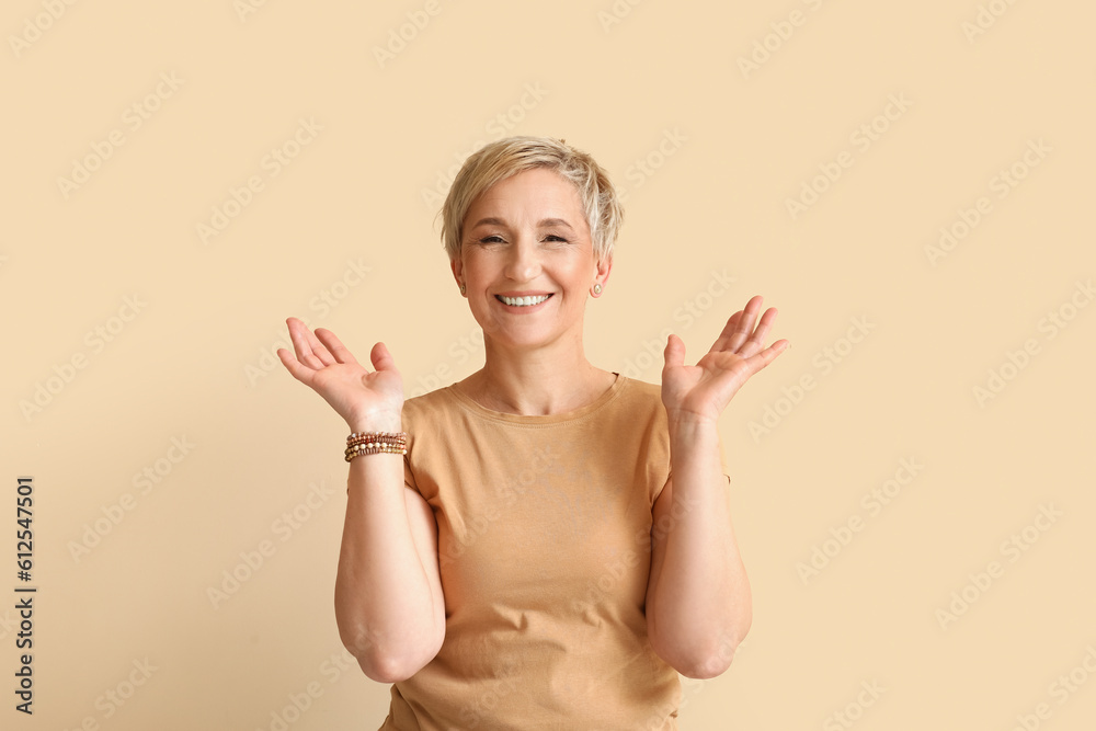 Mature blonde woman on beige background