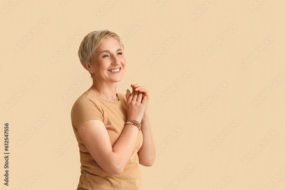 Mature blonde woman on beige background