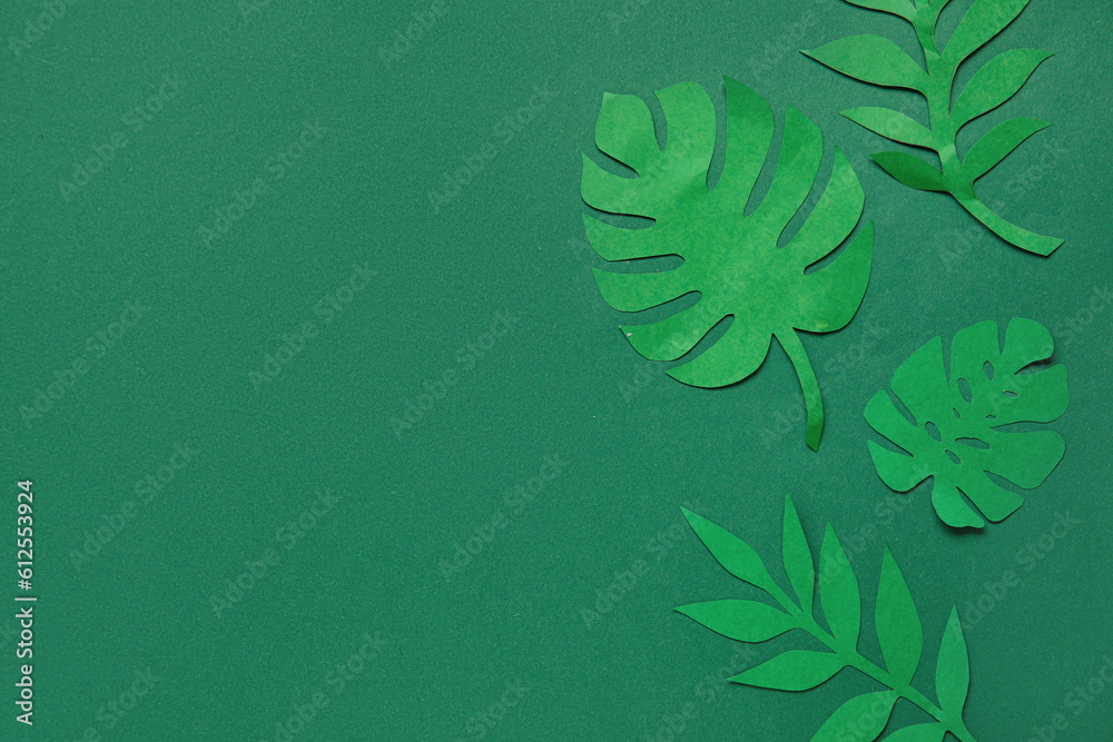 Beautiful origami leaves on green background