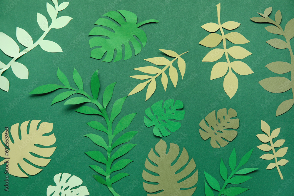 Beautiful origami leaves on green background