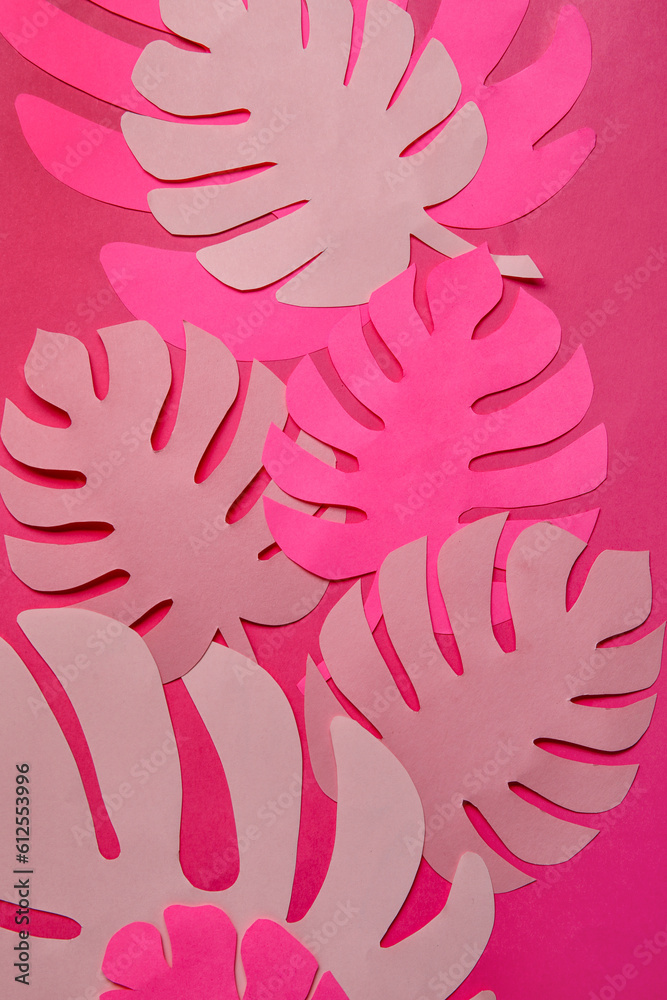 Beautiful origami leaves on pink background