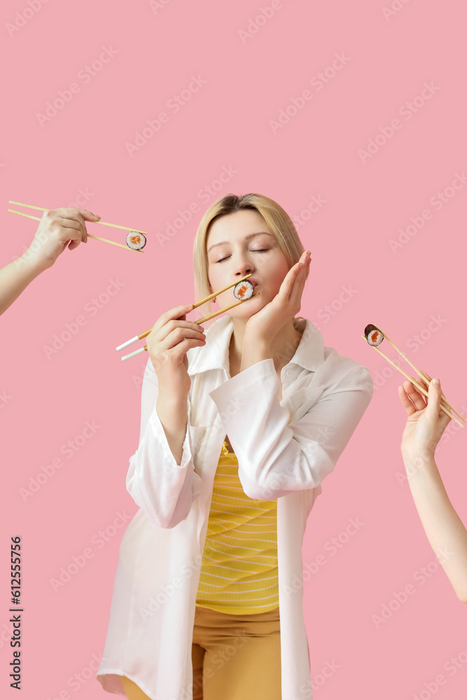 Young woman and female hands with sushi rolls on pink background