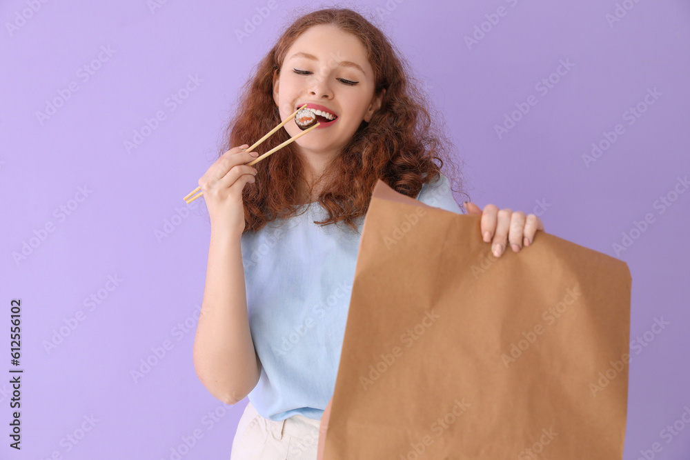 Young woman with sushi roll and paper bag on lilac background